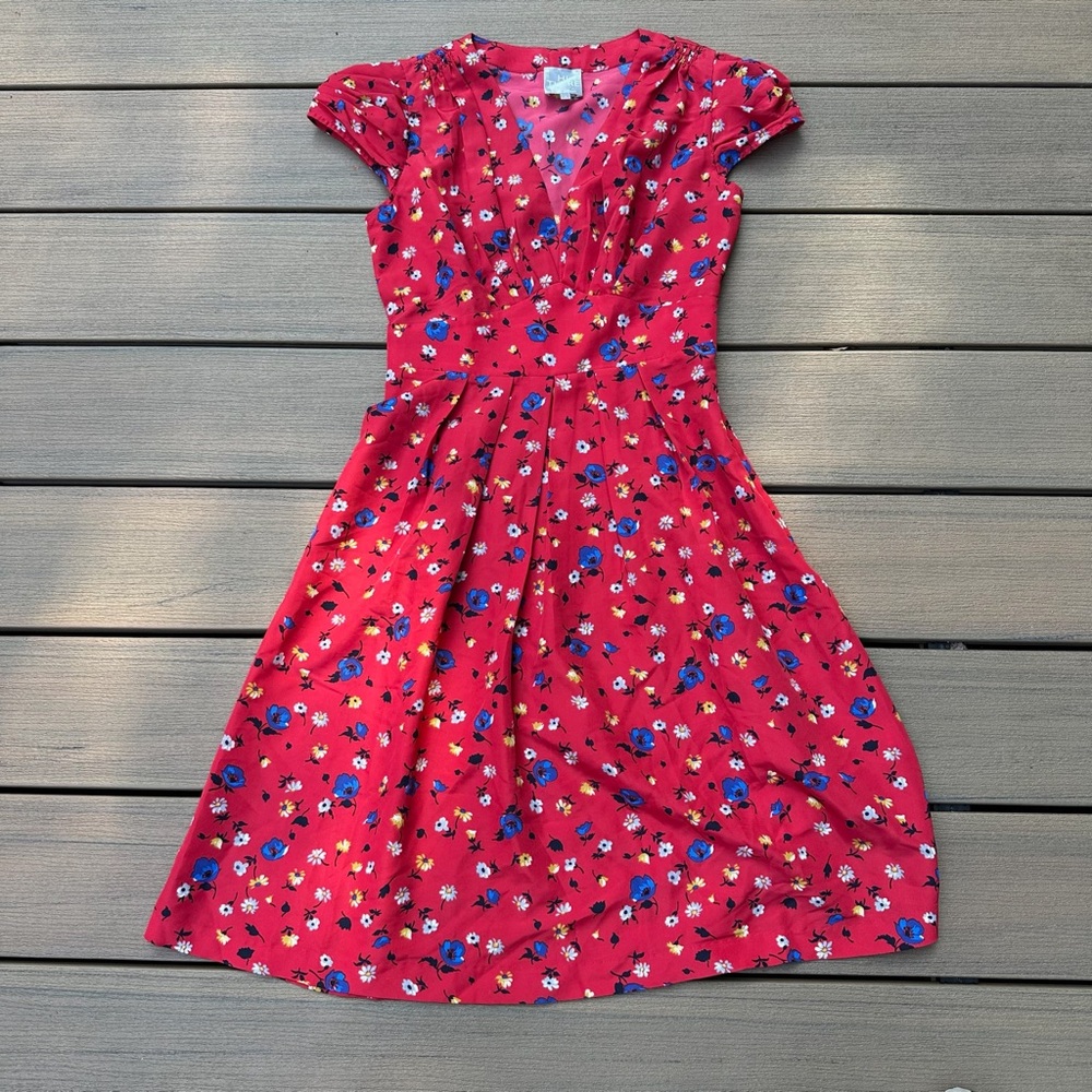 Anthropologie cute V neck red dress with blue, white and yellow flowers.